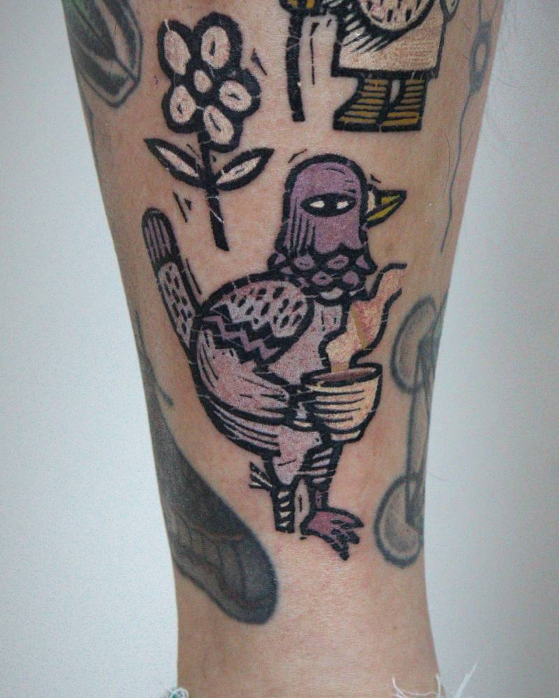 Pop art style rock dove tattoo located on the shin.