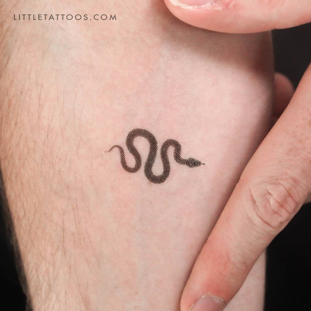 Small dot snake temporary tattoo located on the inner forearm.