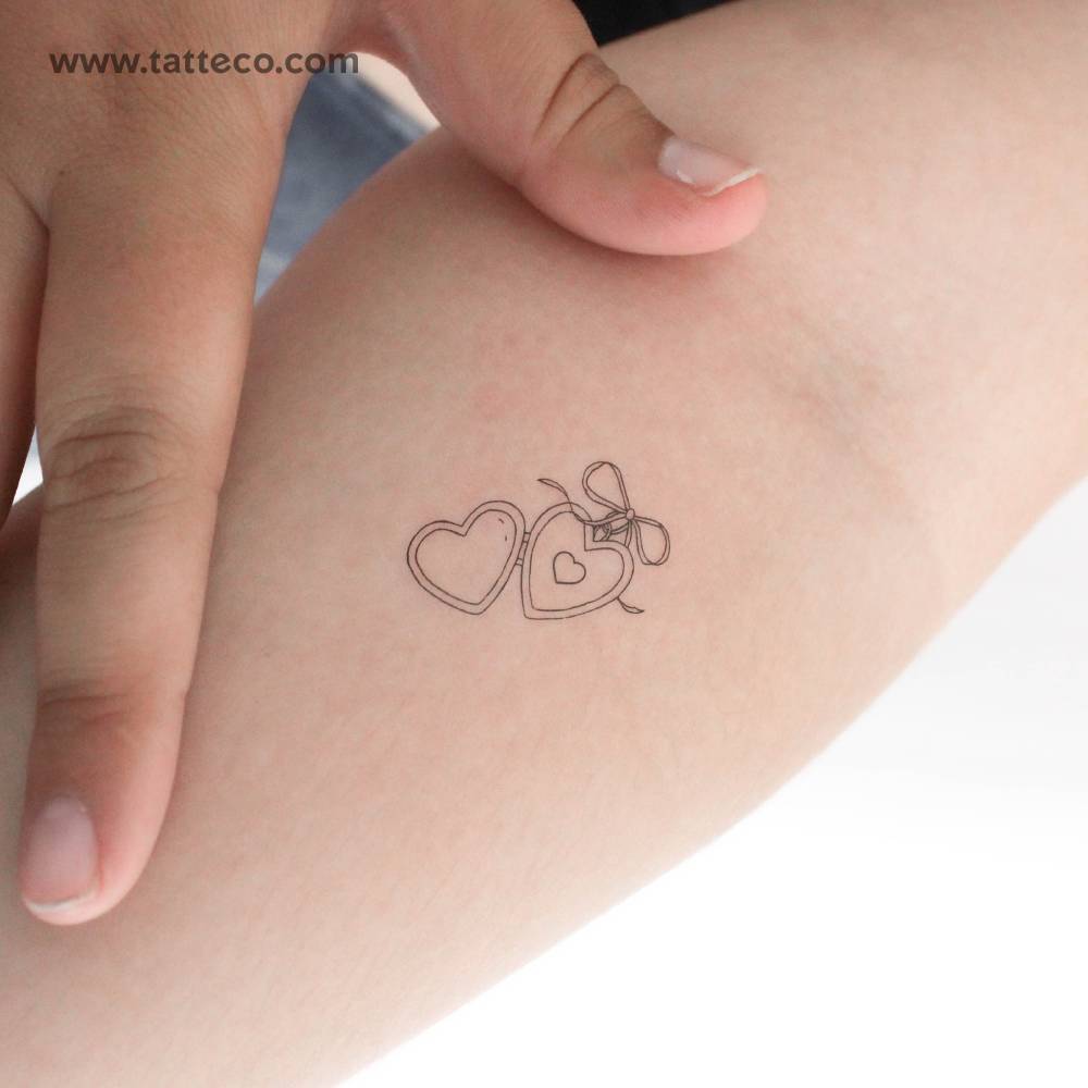 Small heart pendant temporary tattoo in fine line style.