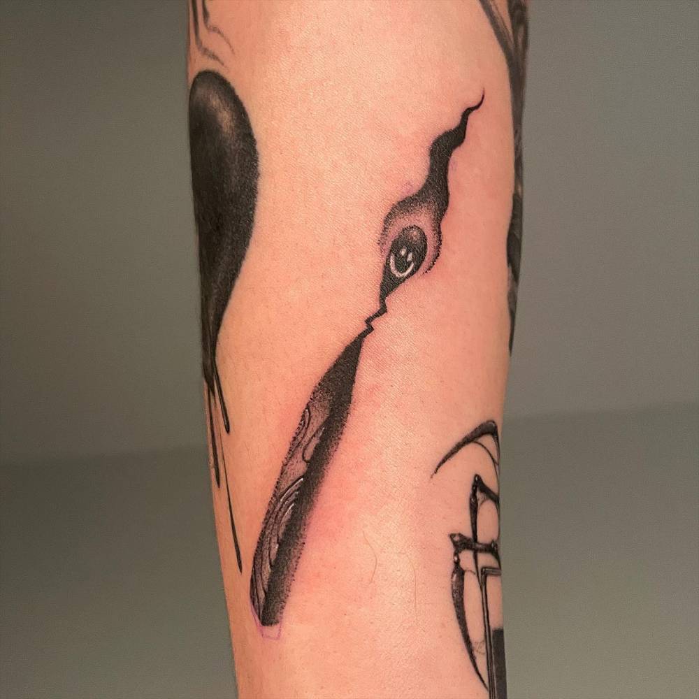 Matchstick tattoo in dotwork style located on the inner forearm.