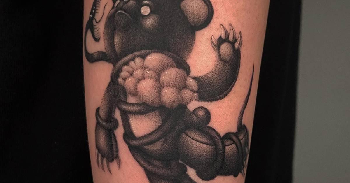 Teddy bear tattoo located on the forearm, done in