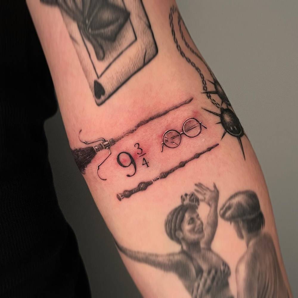 Platform 9 3/4tattoo located on the inner forearm, illustrative style.