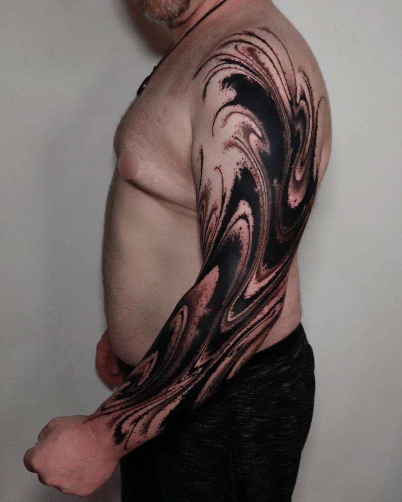 Abstract tattoo sleeve in blackwork style.
