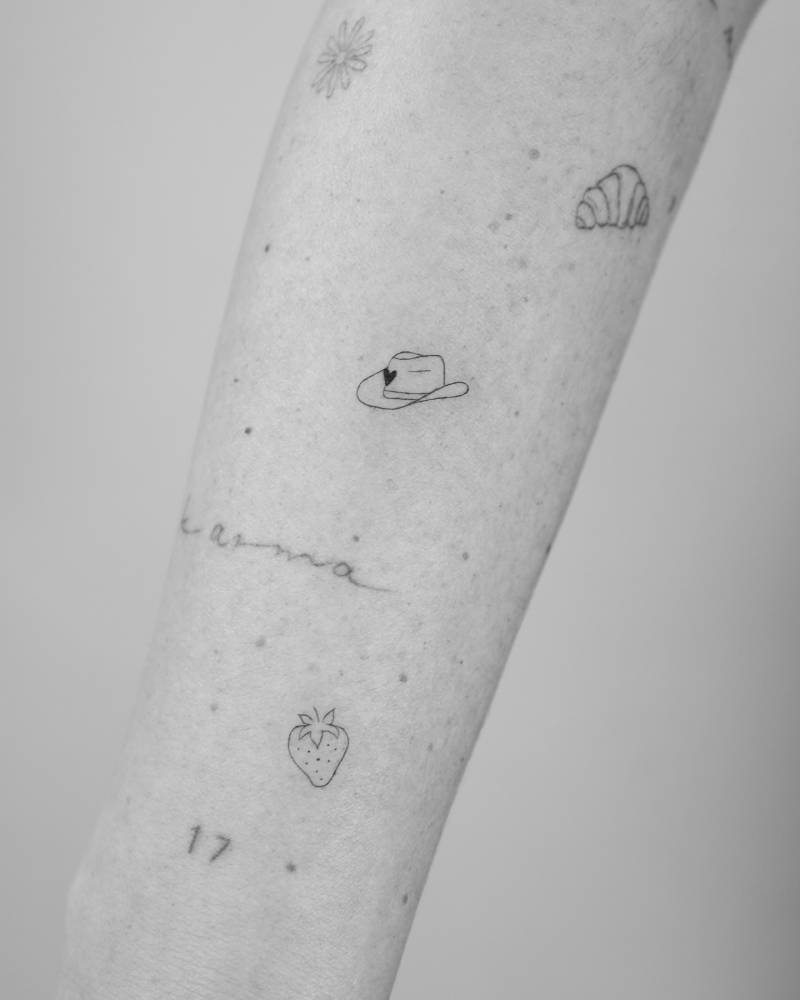 Cowboy hat tattoo in fine line style located on the forearm.