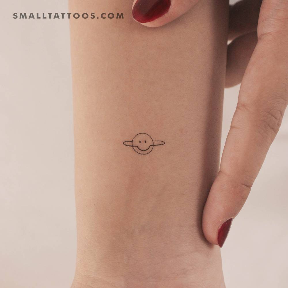 Smiley Saturn temporary tattoo located on the wrist.