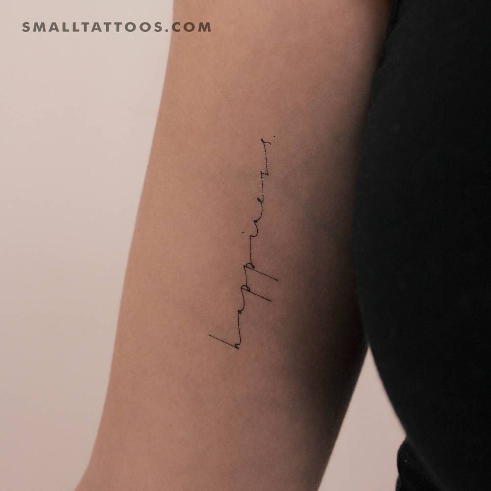 Handwritten font word 'happiness' temporary tattoo located on the inner arm.