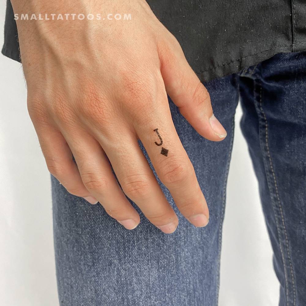 Minimalistic style Jack Of Diamonds temporary tattoo placed on the finger.