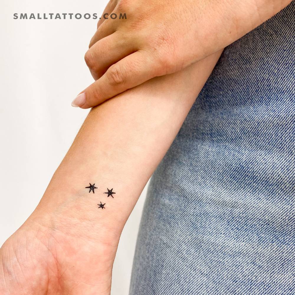 Minimalist three stars temporary tattoo located on the wrist.
