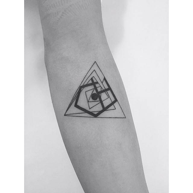 Abstract geometric tattoo located on the inner forearm.