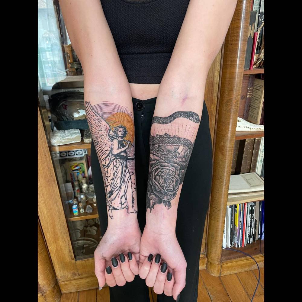 Angel and snake tattoos located on the inner forearm.