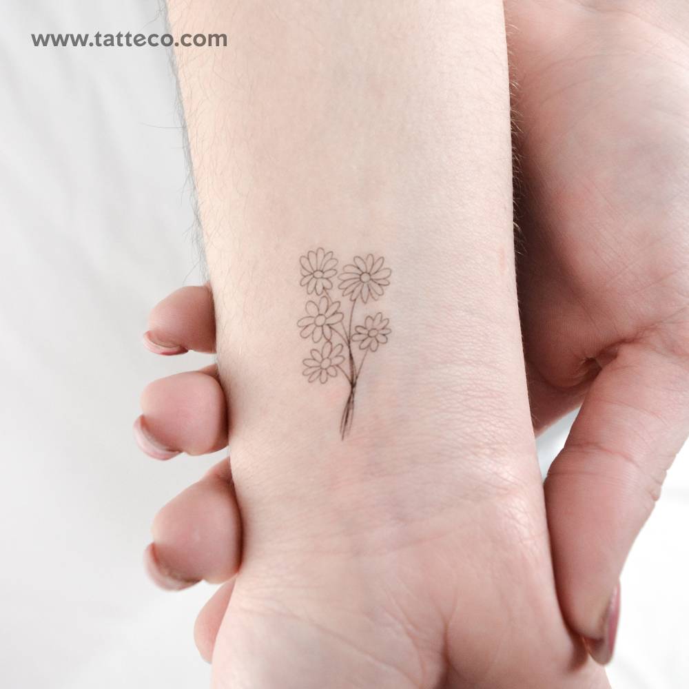 Fine line style daisy bouquet temporary tattoo located on the wrist.