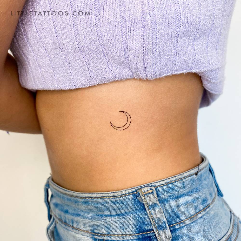 Fine line crescent moon temporary tattoo located on the rib.