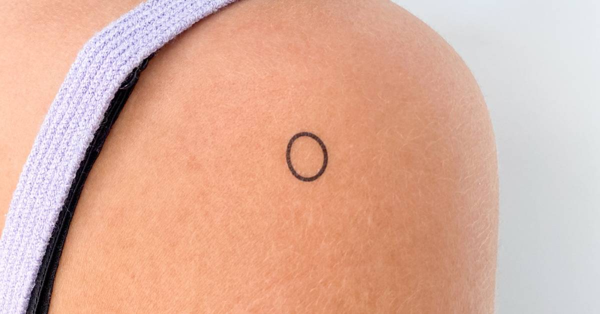 Little minimalistic circle temporary tattoo located on
