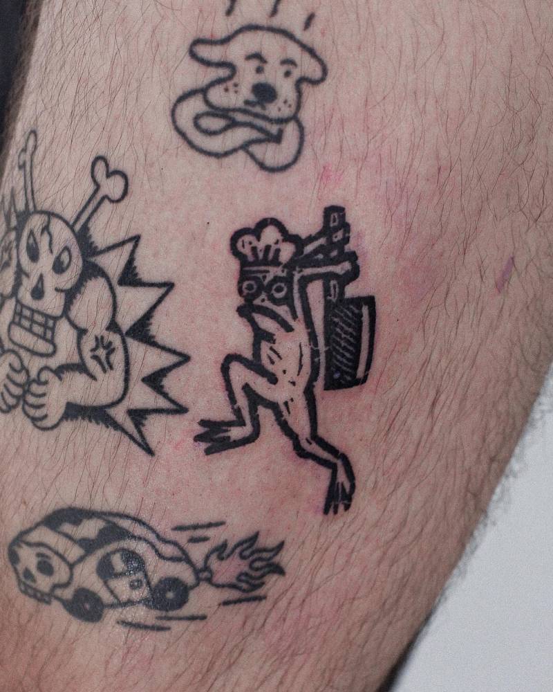 Chef frog tattoo located on the thigh, done in pop art style.