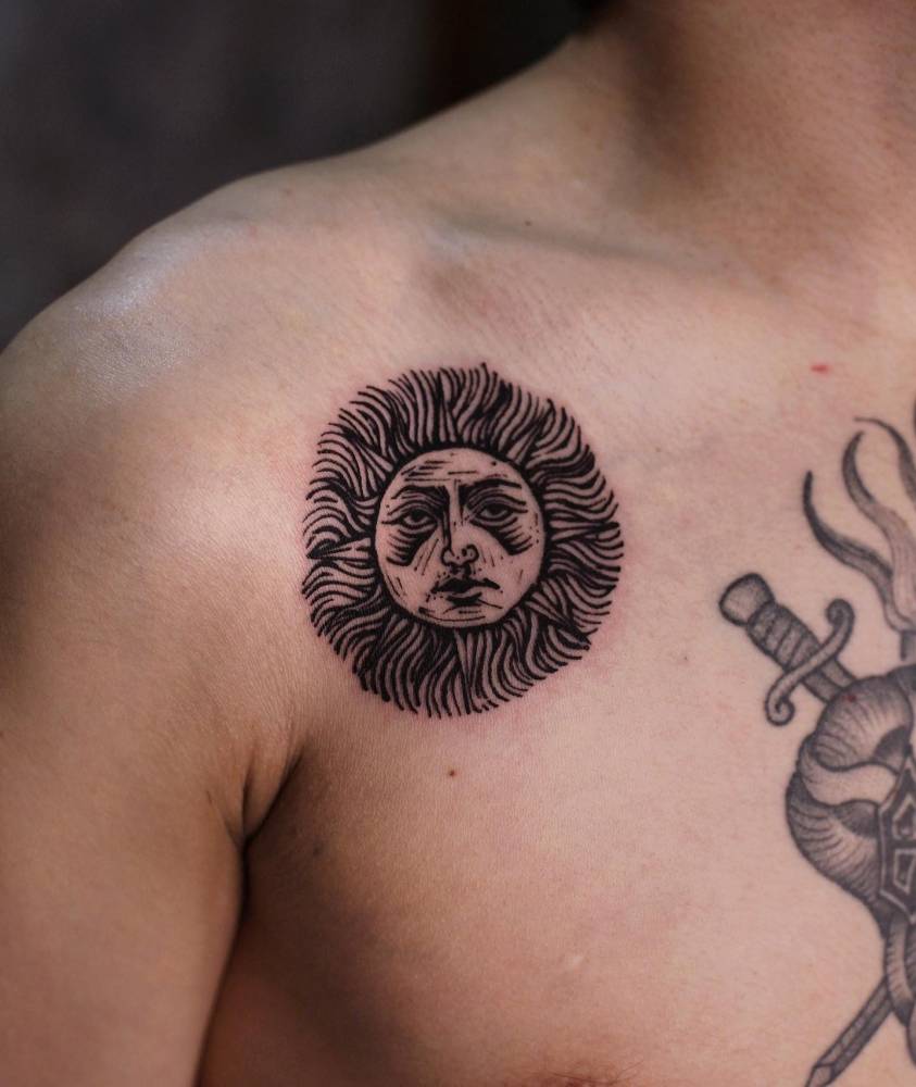 Engraving style inti sun tattoo located on the shoulder.