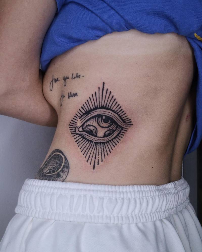 Eye tattoo located on the rib, done in blackwork style.