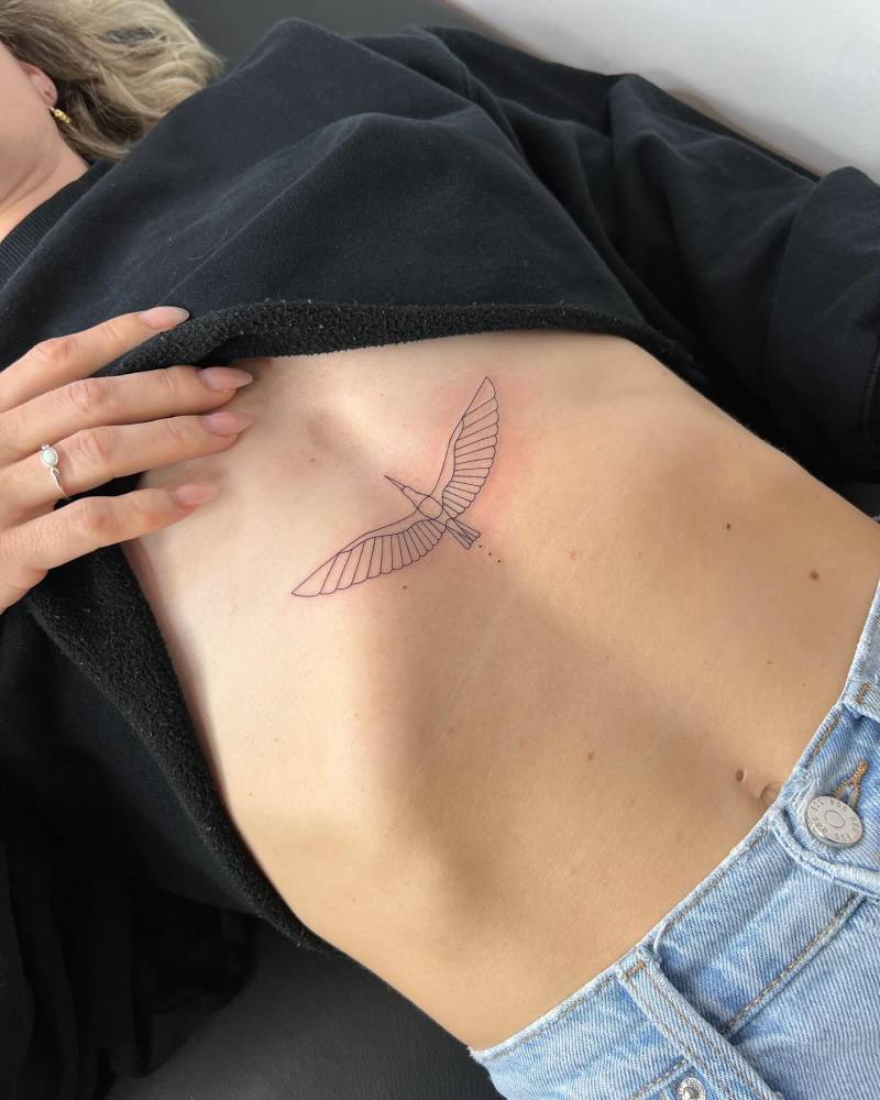 Fine line style egret tattoo located on the stomach.