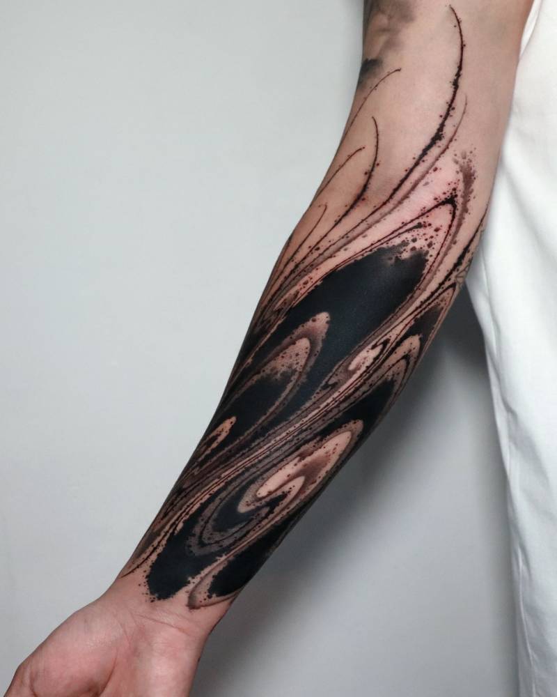 Abstract flow tattoo located on the inner forearm, blackwork style.
