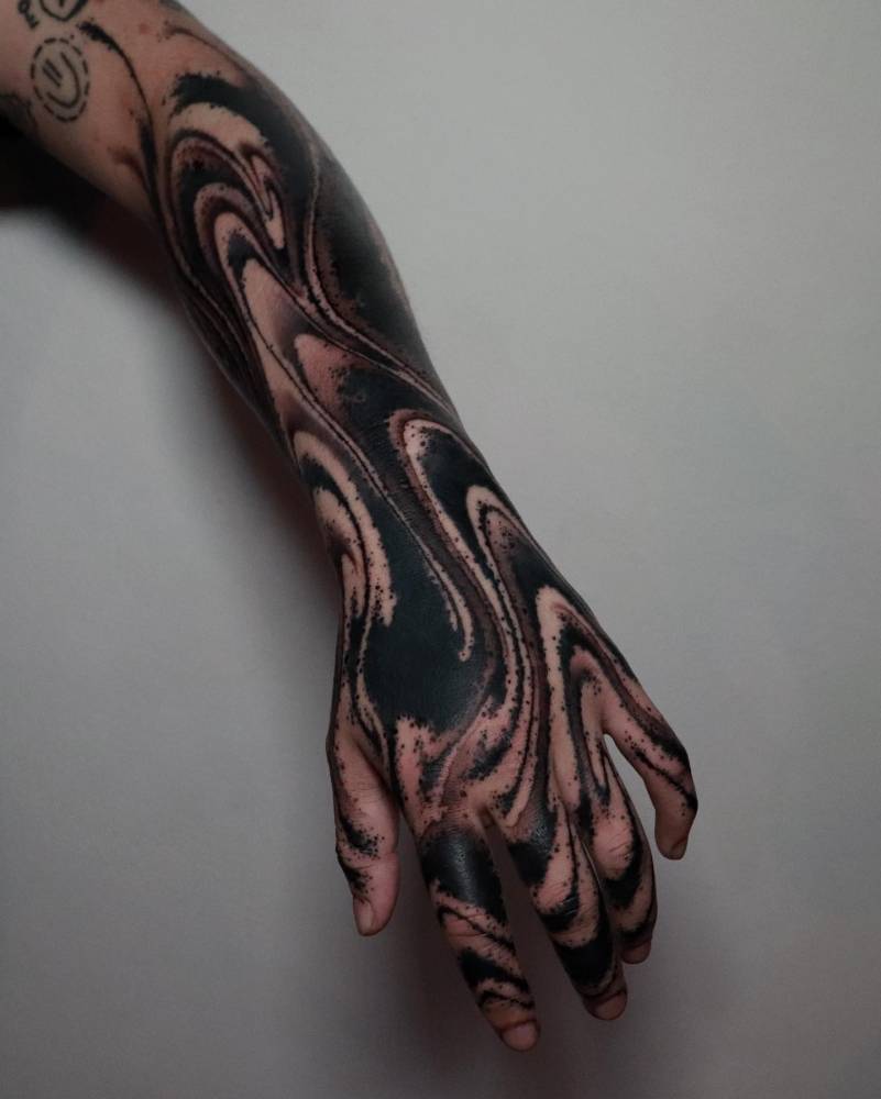 Blackwork style abstract flow tattoo located on the forearm and hands.