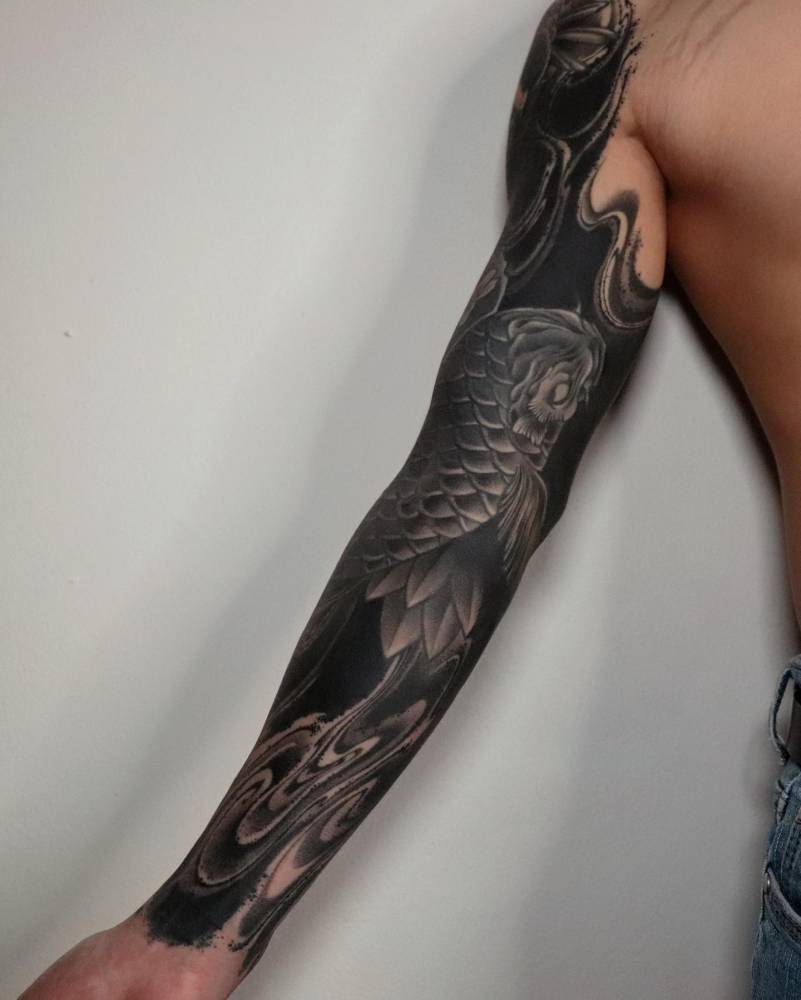 Koi fish tattoo sleeve in blackwork style.