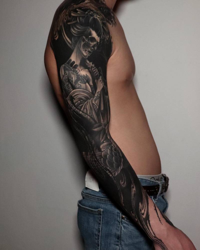 Geisha skeleton tattoo sleeve in black and grey style.