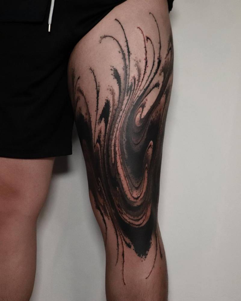 Blackwork style abstract flow tattoo located on the thigh.