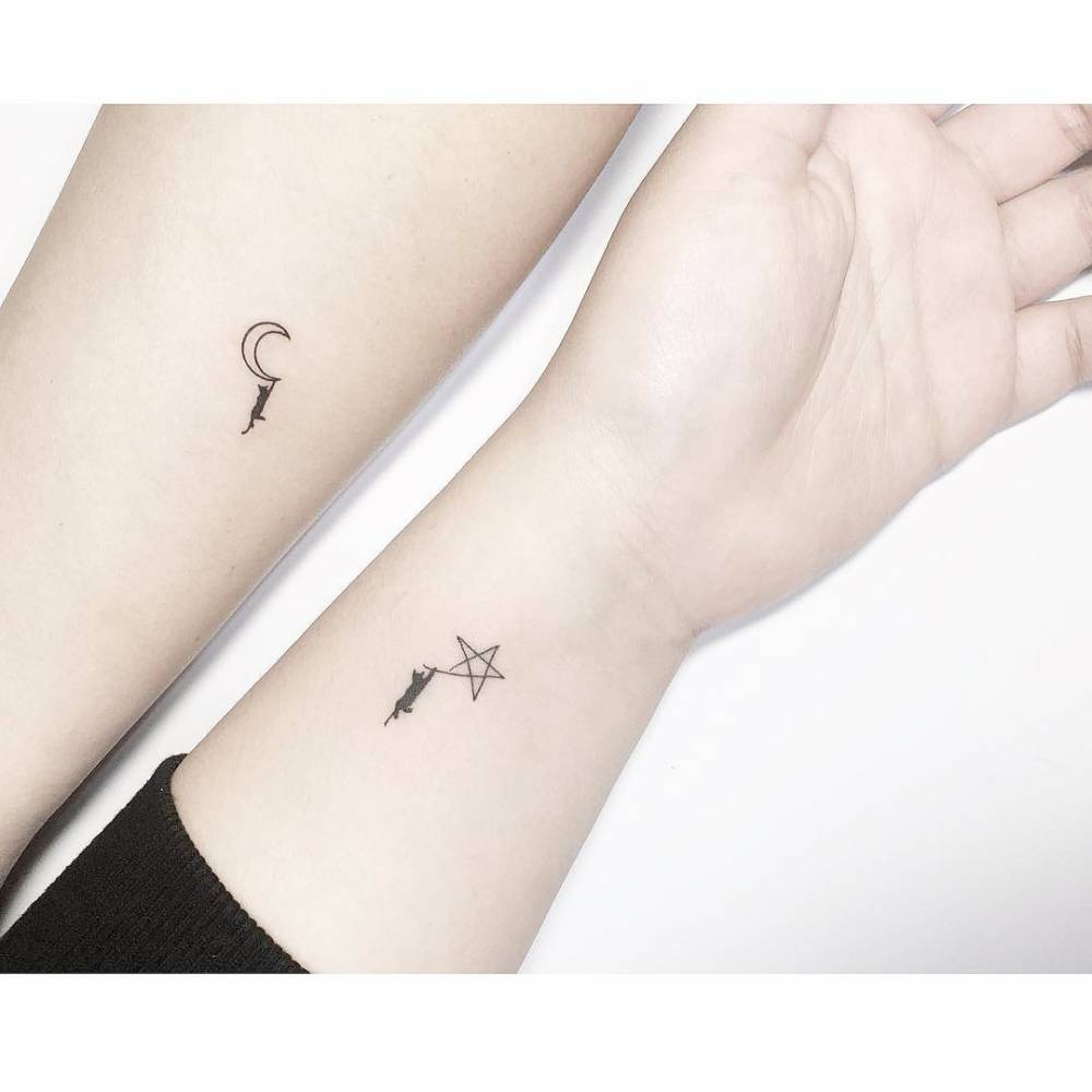 Matching cat hanging from star and moon tattoo for best friends.