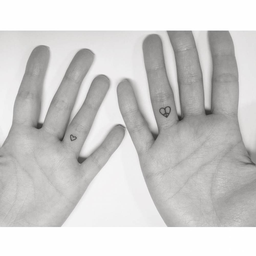 Matching hearts tattoo in minimalistic style for couple.