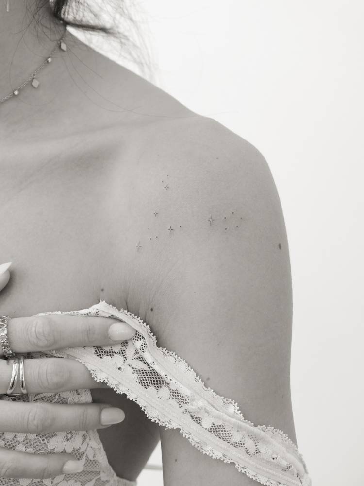 Pisces constellation tattoo located on the shoulder.