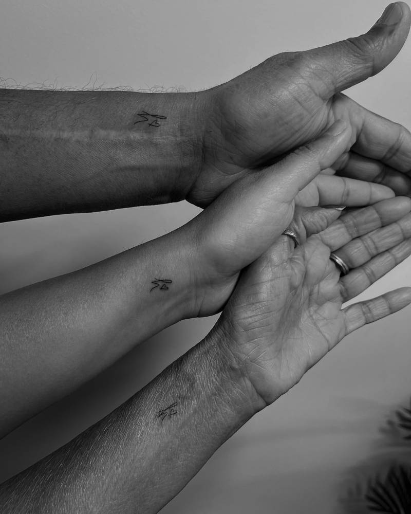 Matching minimalistic letter "H" and heart tattoo for parents and daughter.