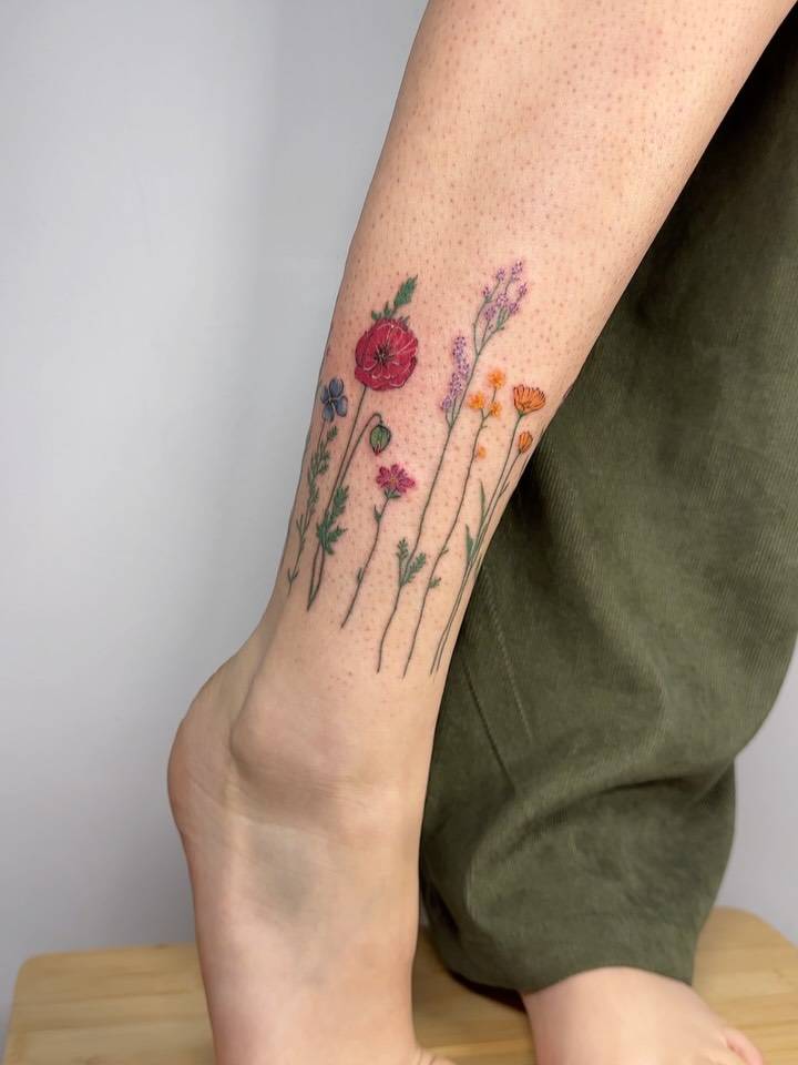 Flowers tattoo located on the ankle, done in illustrative style.