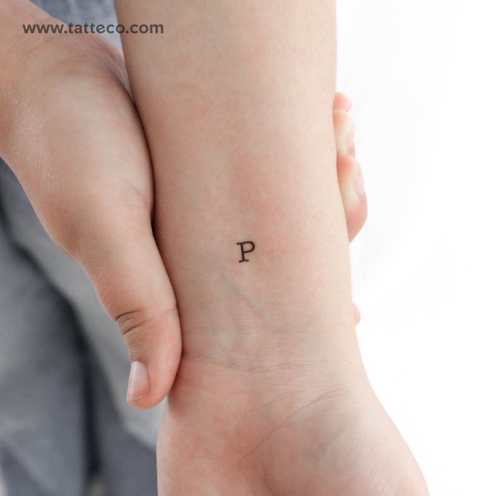 "P" uppercase typewriter letter temporary tattoo located on the wrist.