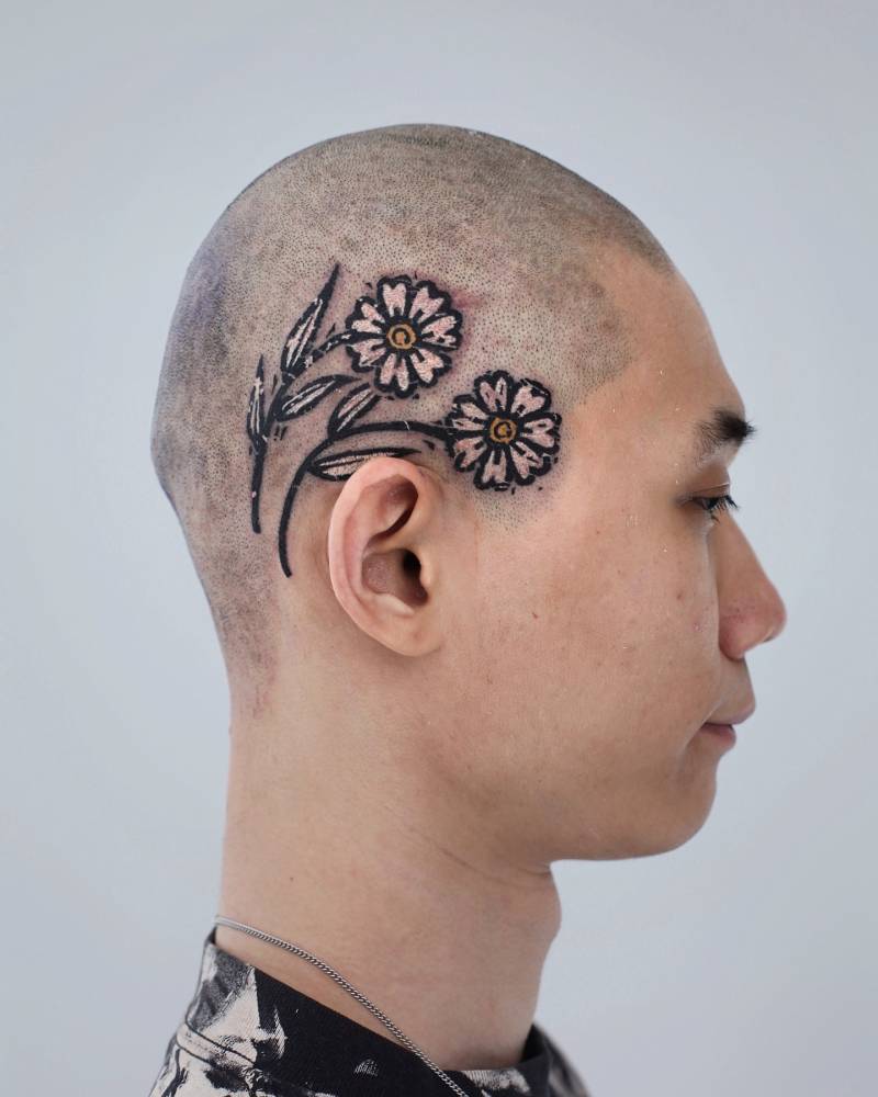 Pop art style flowers tattoo located on the head.