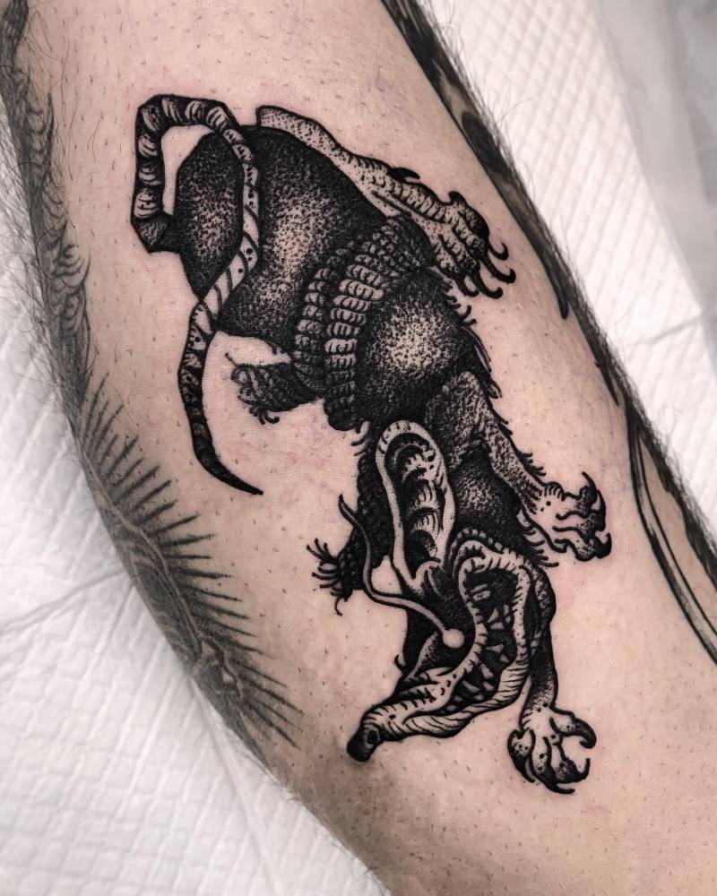 Engraving style rat tattoo located on the calf.