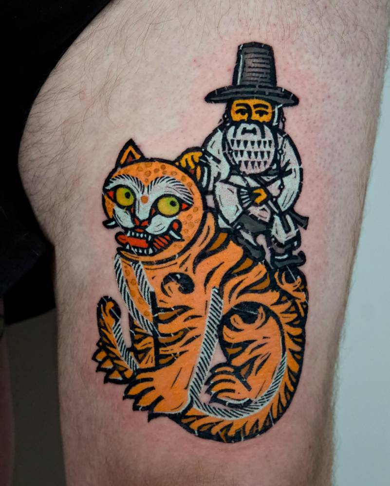 Gnome riding a tiger tattooed on the thigh, pop art style.