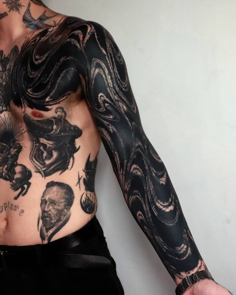 Abstract cover up tattoo sleeve done in blackwork style.