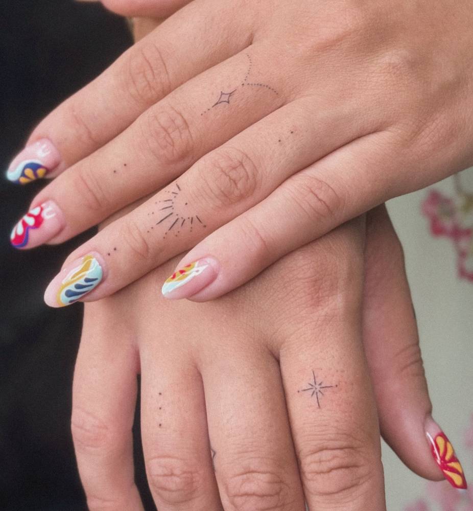 Ornamental finger composition tattoos in fine line style.