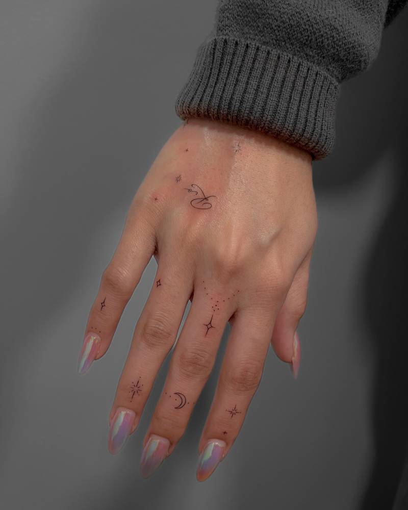 Hand composition tattoos in fine line style.