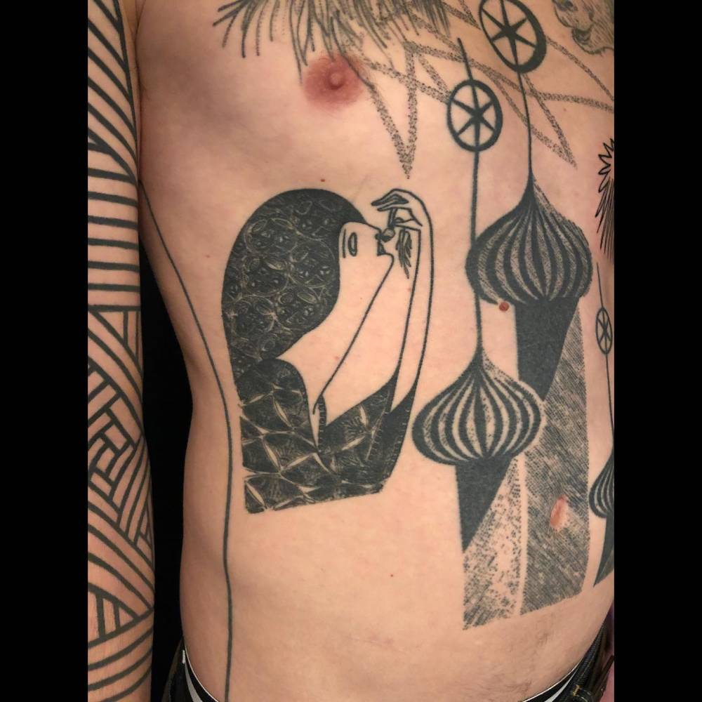 Contemporary style woman portrait tattoo located on the rib.