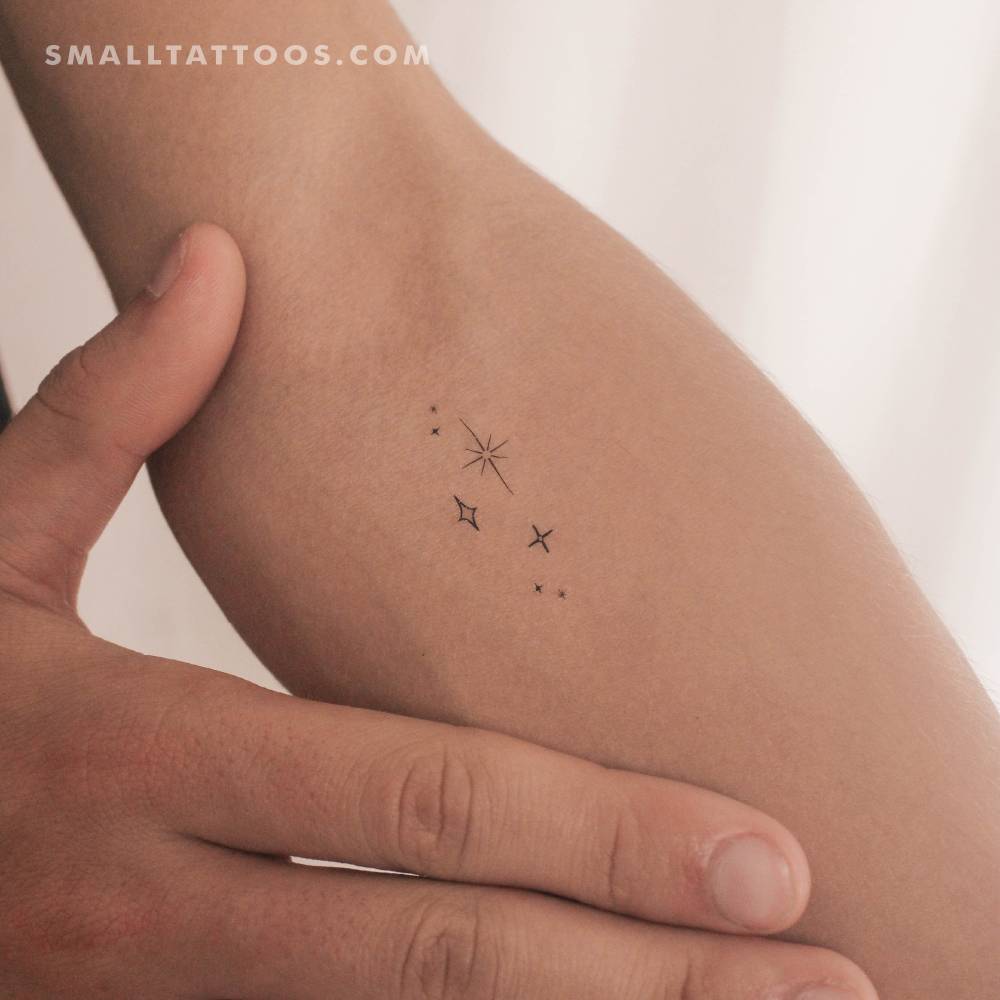 Stars sparkles temporary tattoo located on the inner forearm.