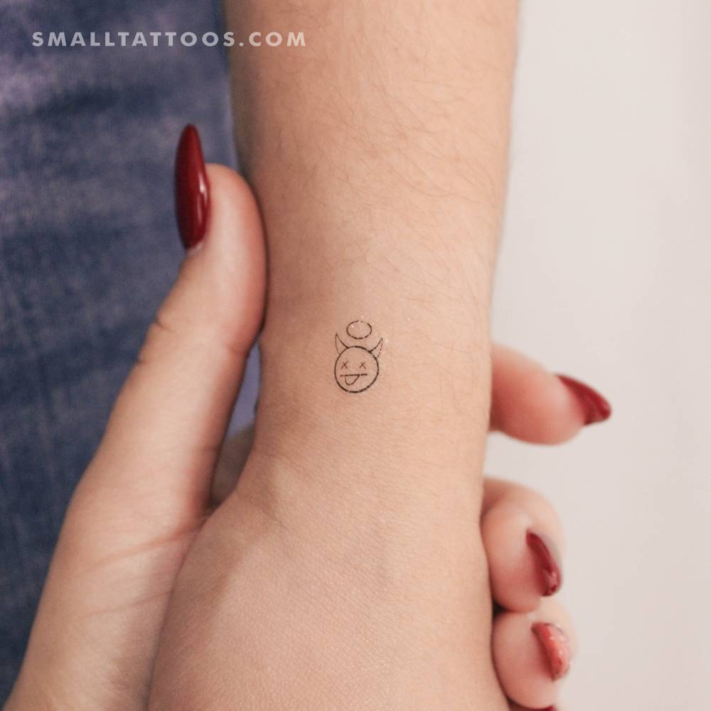 Minimalistic style devil temporary tattoo located on the wrist.