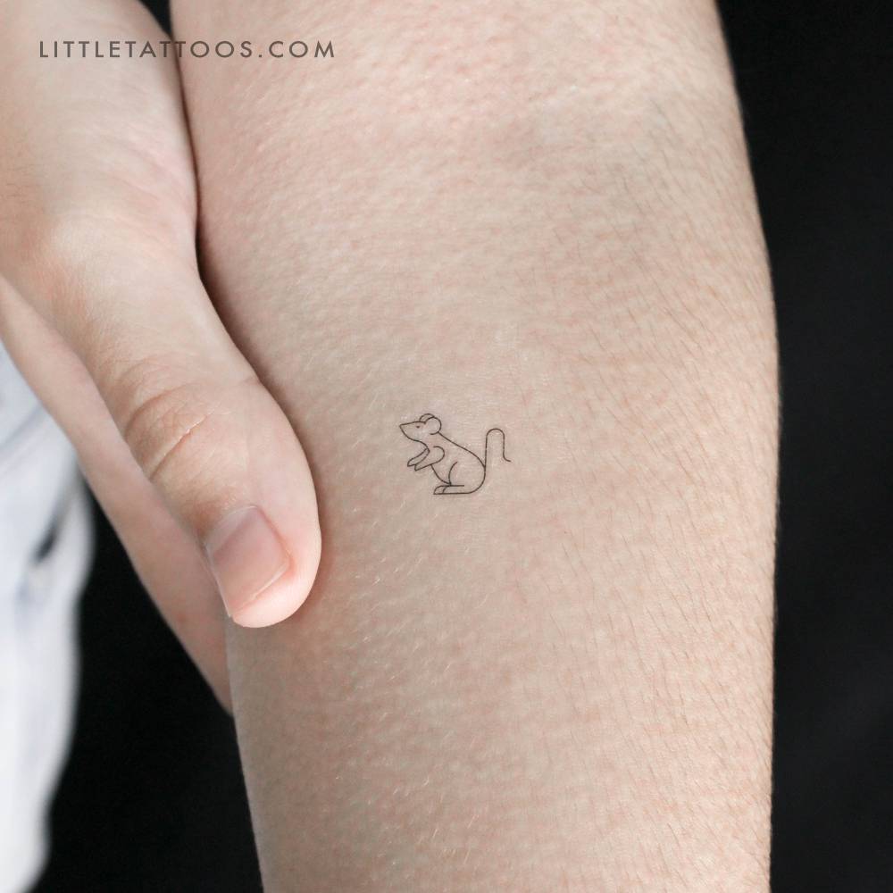 Tiny minimalistic mouse temporary tattoo located on the inner forearm.