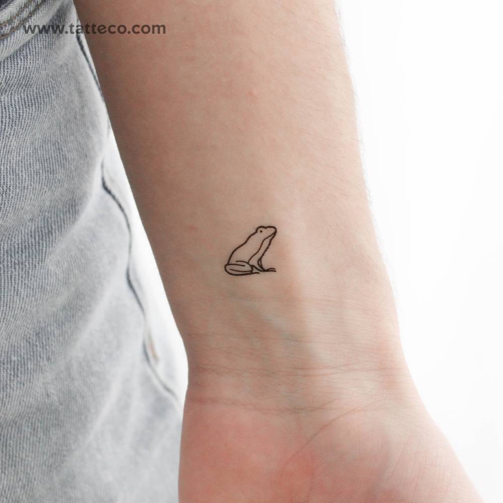 Frog temporary tattoo in minimalistic style placed on the wrist.