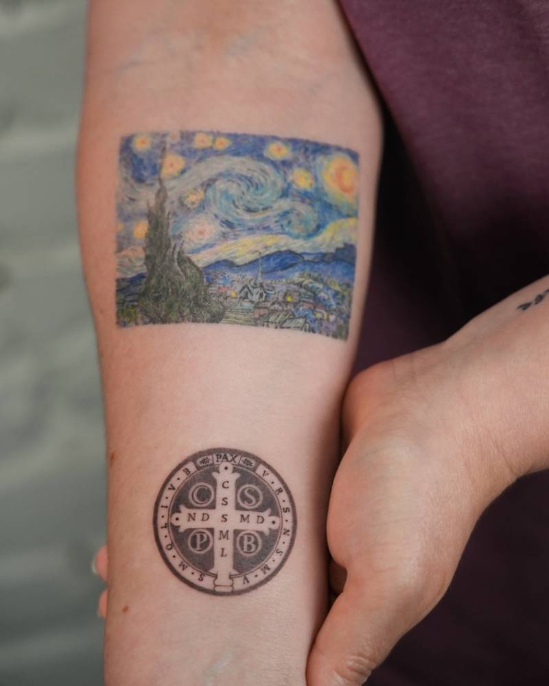Healed 'The Starry Night' and fresh Saint Benedict Medal tattooed on the inner forearm.