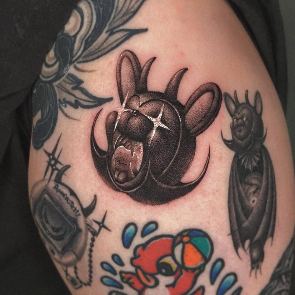 Devil teddy bear portrait tattoo in dotwork style placed on the shoulder.