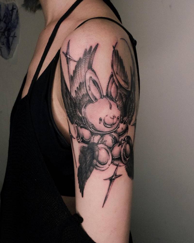 Teddy bunny seraphim tattoo located on the upper arm.