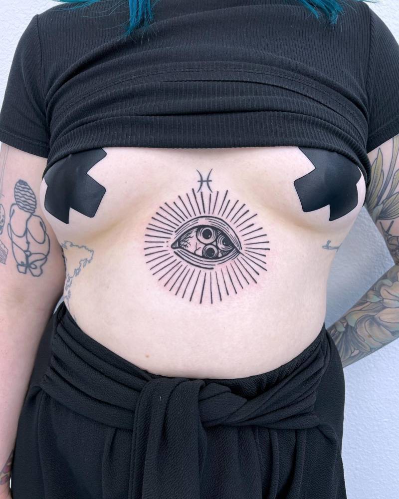 Eye tattoo in engraving style located on the stomach.
