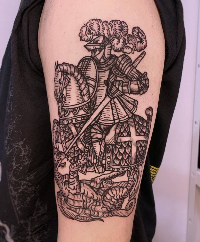 Knight tattoo in engraving style located on the upper arm.