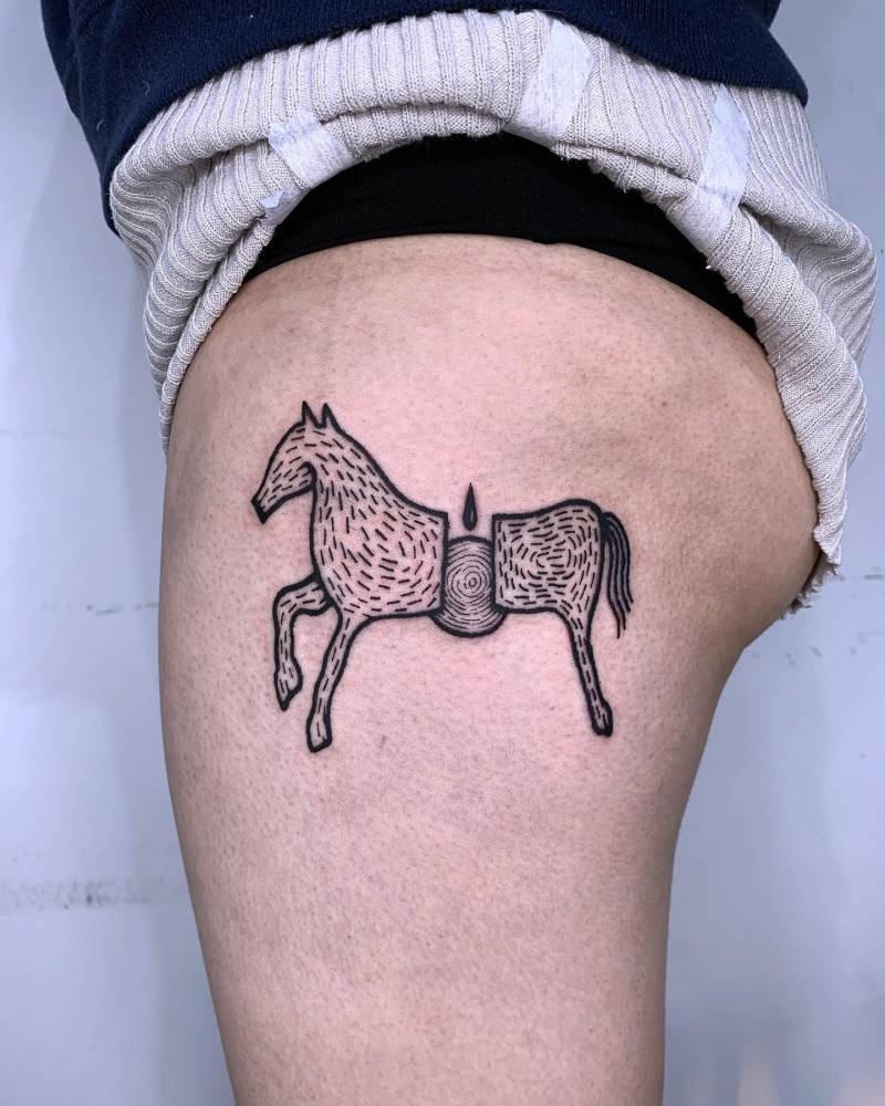 Engraving style horse tattoo located on the hip.