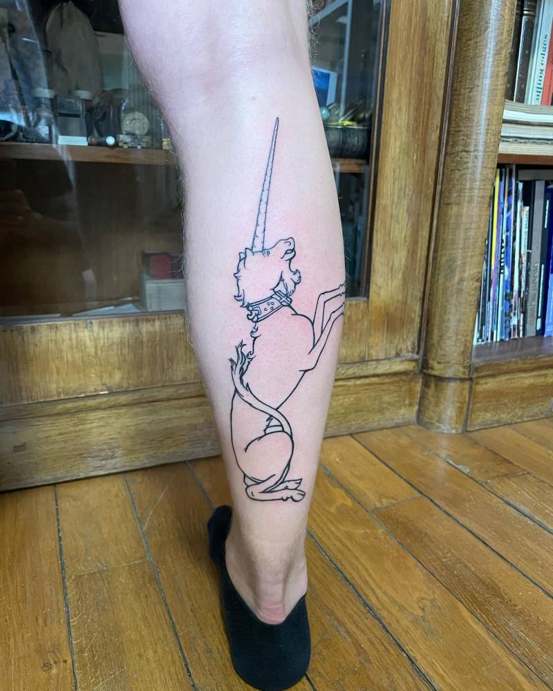 Line art style unicorn tattoo located on the calf.